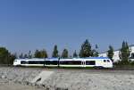 Eastbound bound for Redlands-University Station heading along The Mission Zanja after crossing Mountain View Avenue at grade